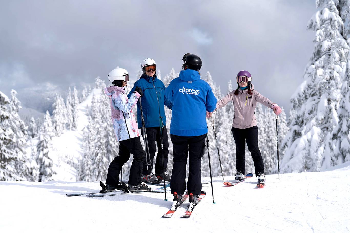 Ski instructor talking to a group of adult students