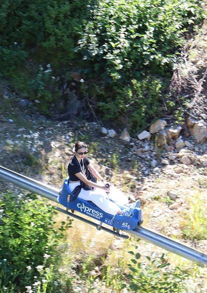 Aerial shot of a woman riding the Eagle Coaster.