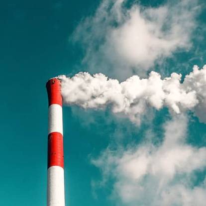 Smoke coming out of a factory chimney.