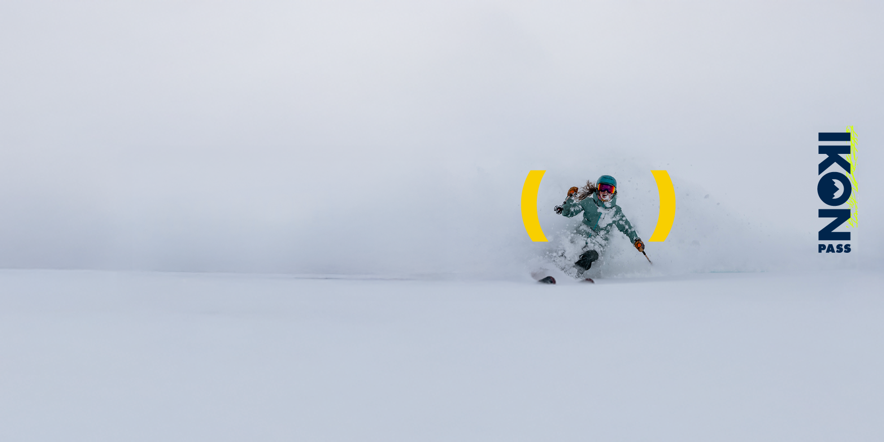 Skier skis through deep snow with the Ikon pass promoted.