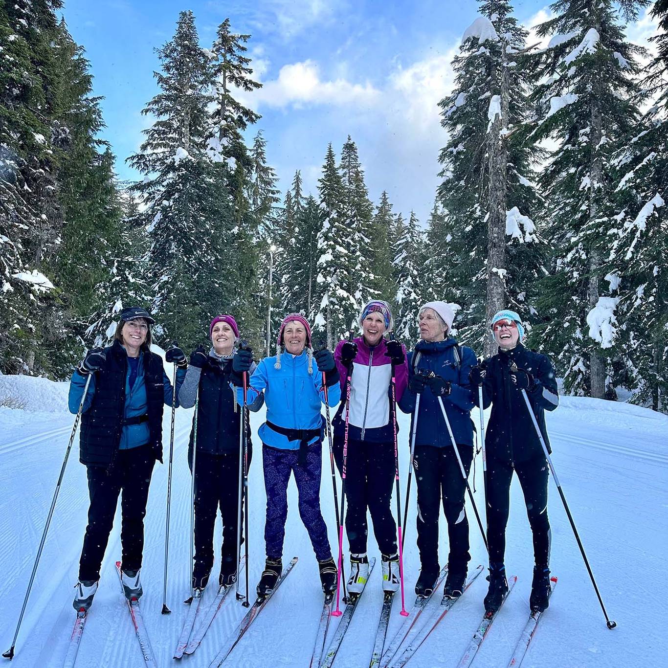 Six cross country women skiers posing.