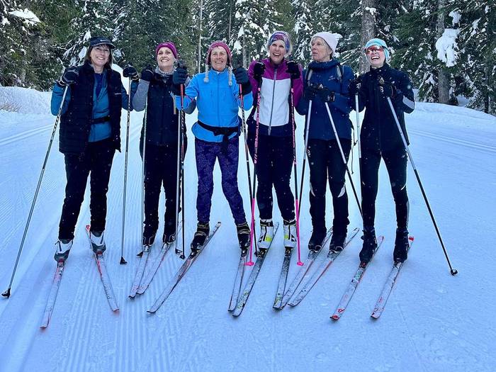 Six cross country women skiers posing.
