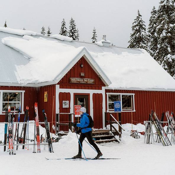 Cross country skier in front of Hollyburn Lodge.