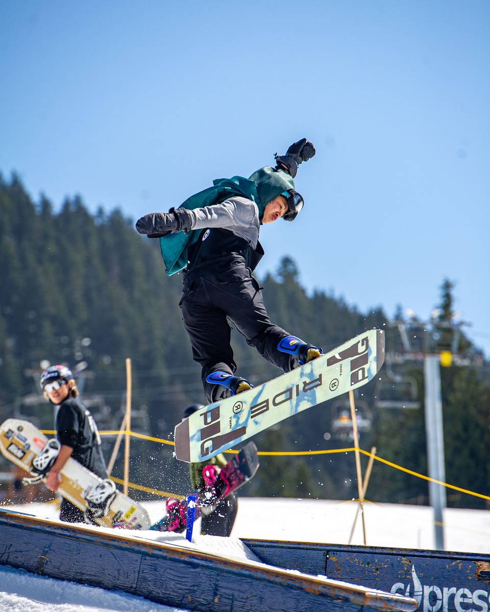 Snowboarder in the terrain park on a box feature