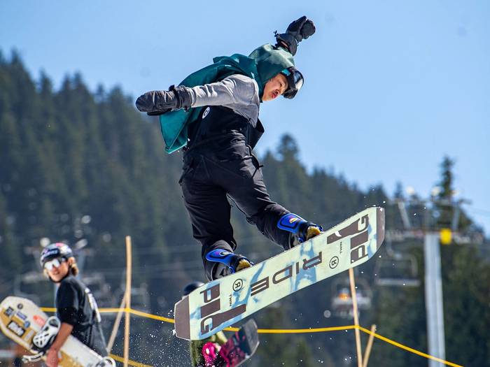 Snowboarder in the terrain park on a box feature