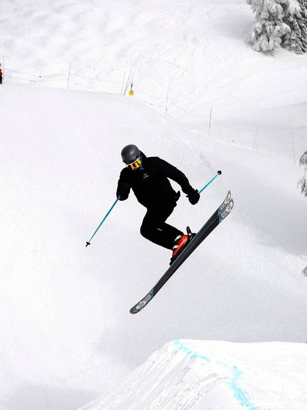 Skier performing a jump in terrain parks.
