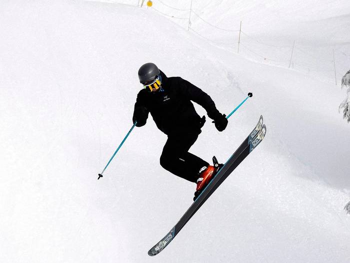 Skier performing a jump in terrain parks.
