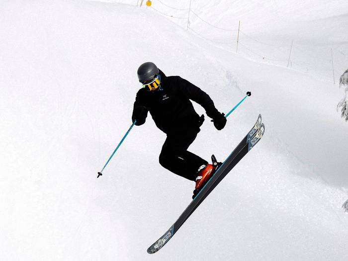 Skier performing a jump in terrain parks.