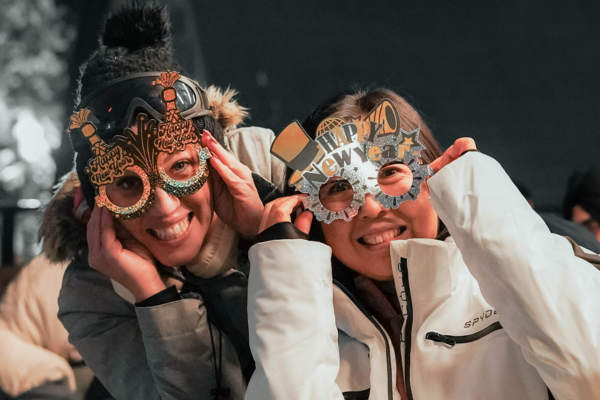 A crowd of people celebrate the New Year on the Cypress Mountain Patio.