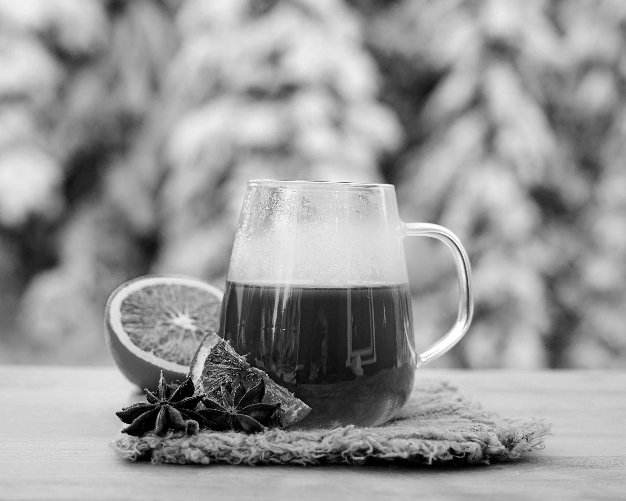 A warm tasty scented tea with orange sits with excellent presentation.