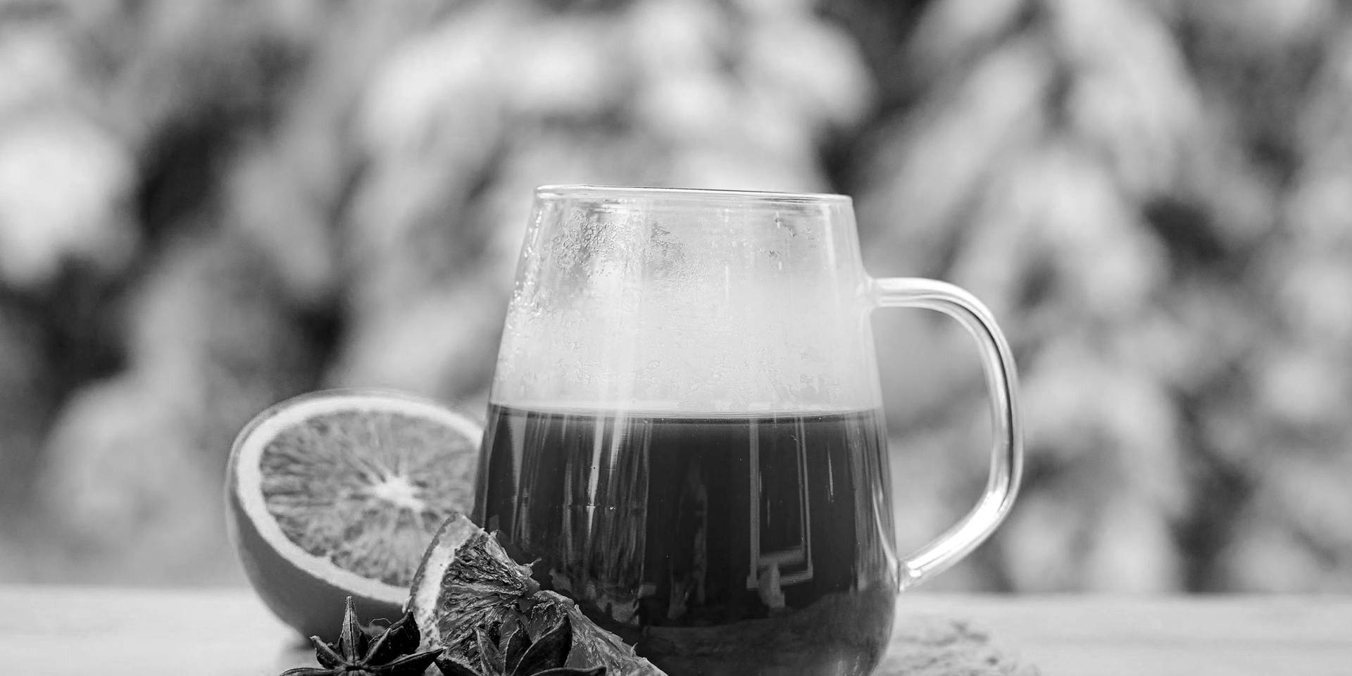 A warm tasty scented tea with orange sits with excellent presentation.