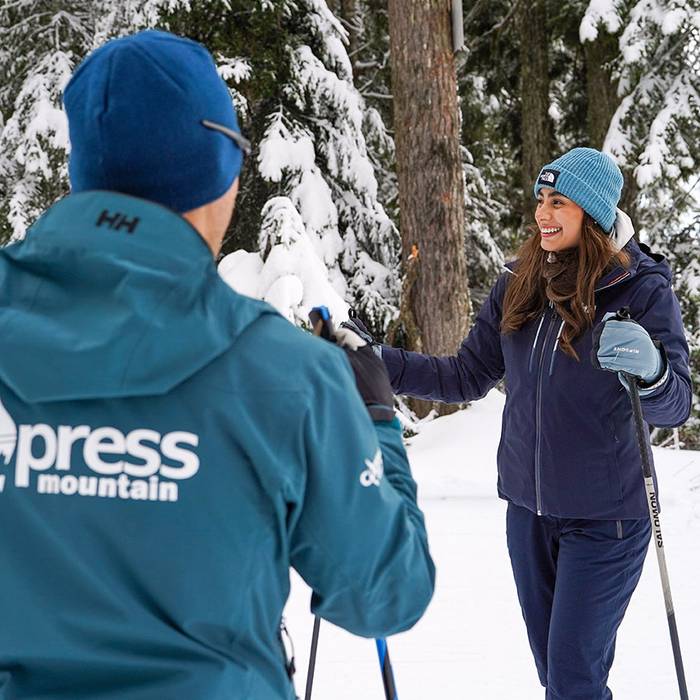 two adults skating through the forest