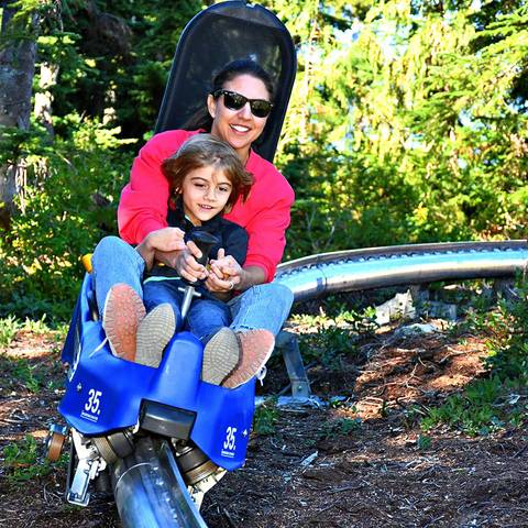 A mother and son riding the Eagle Coaster.