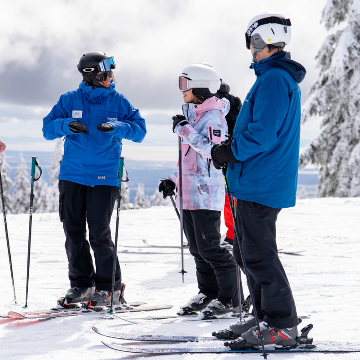 Instructor teaching a group of skiers