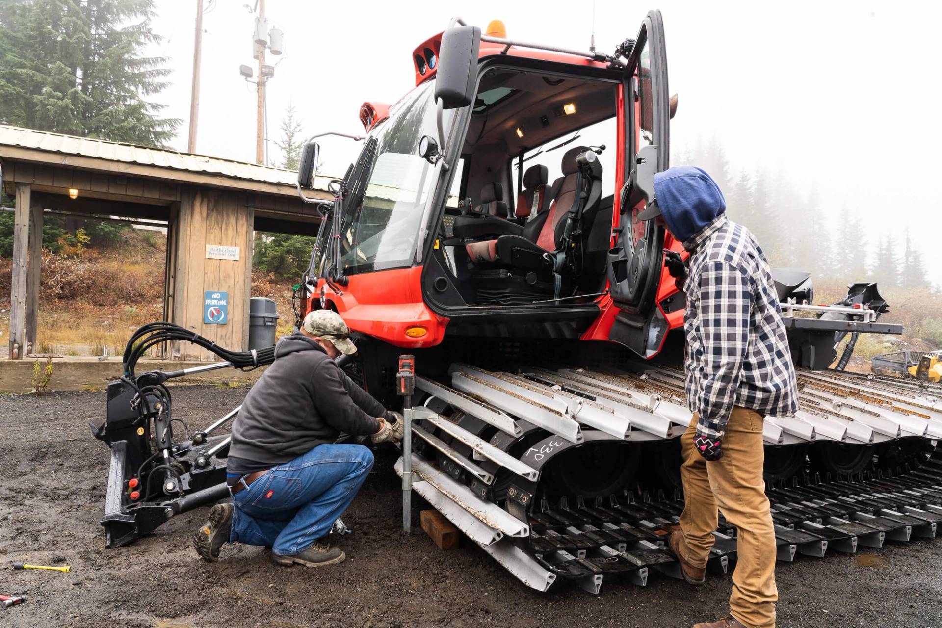 mechanics working on groomer