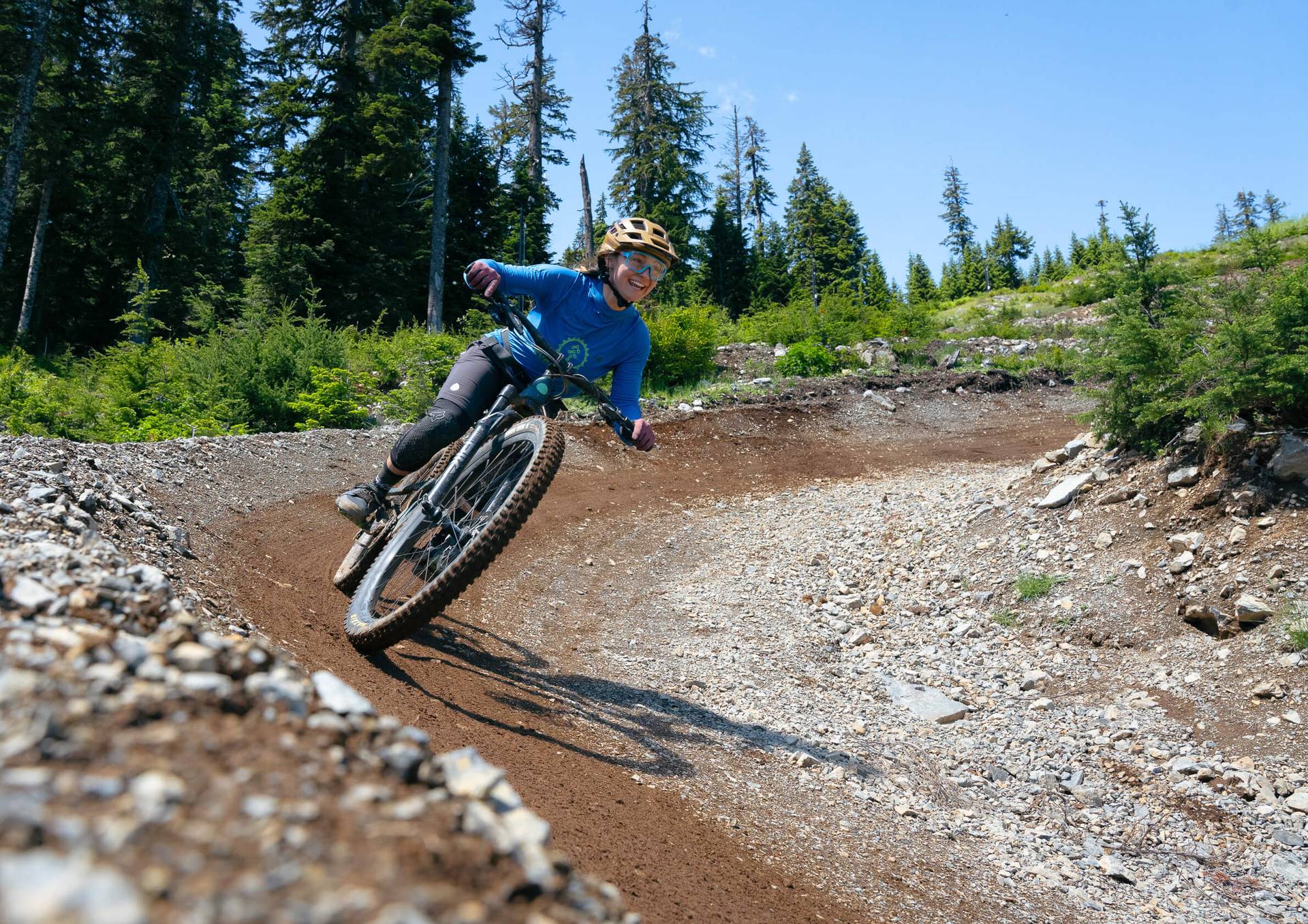 woman riding berm on mountain bike