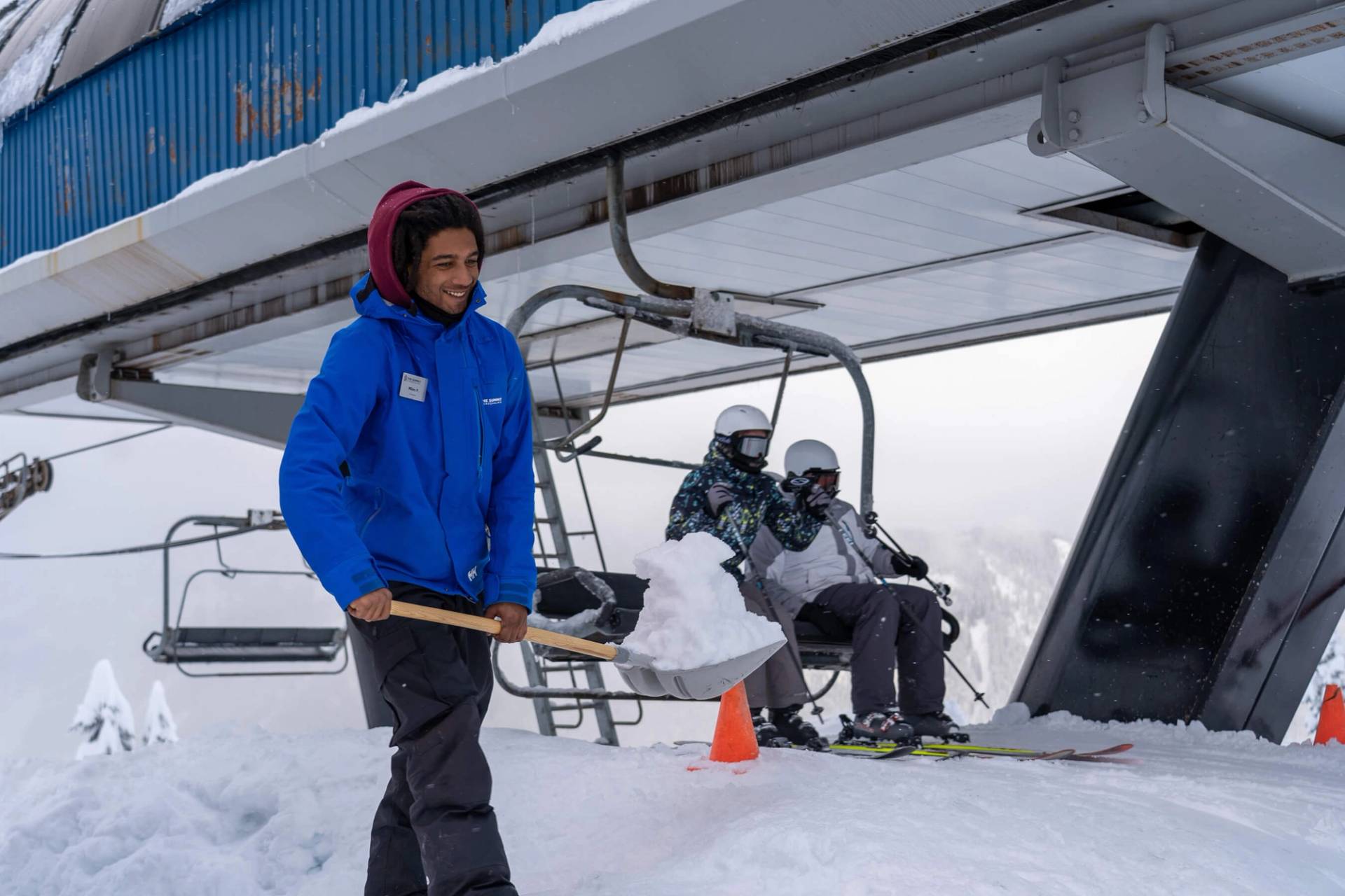 lift operator shoveling snow