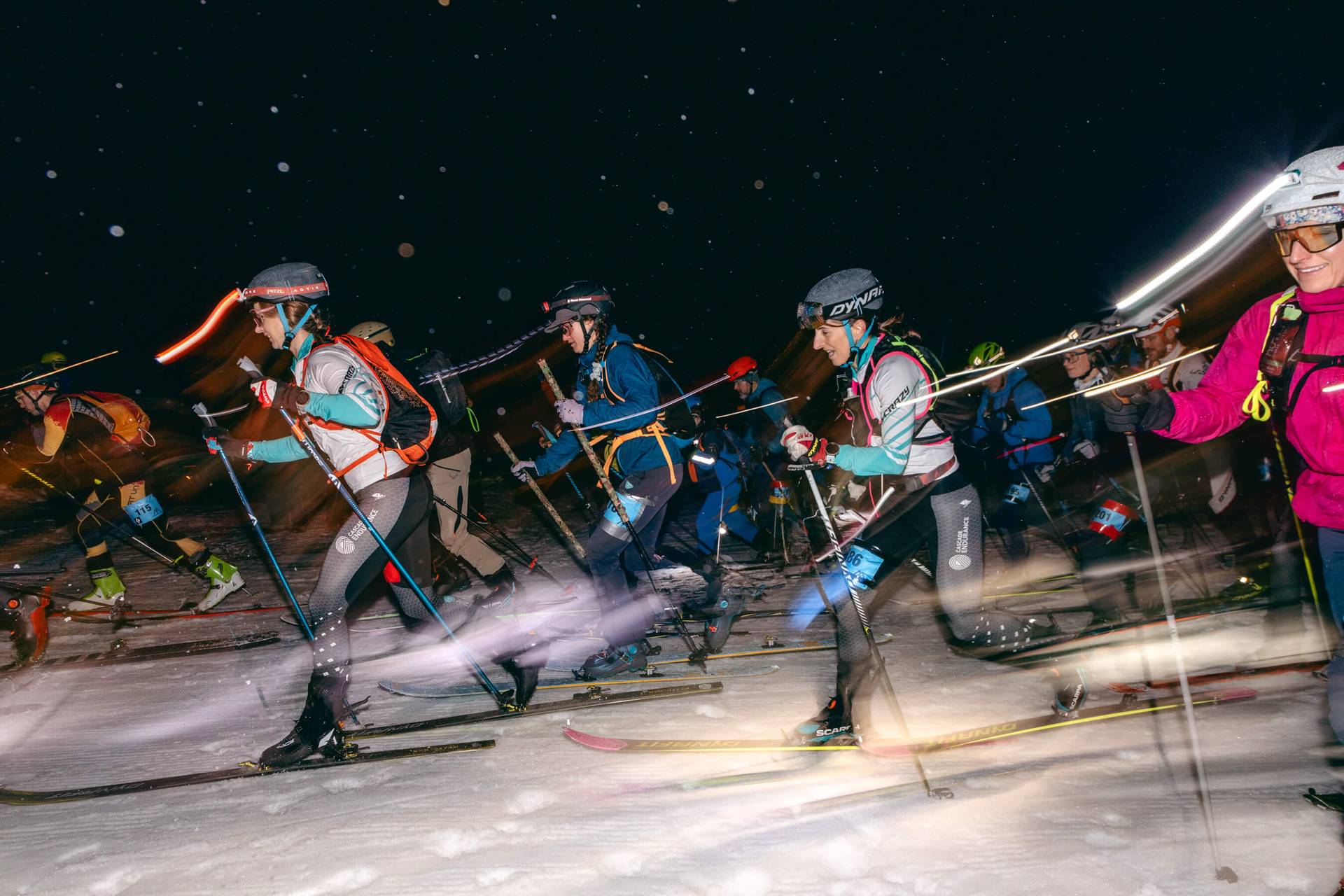 group of skimo racers takes off from start line of race event