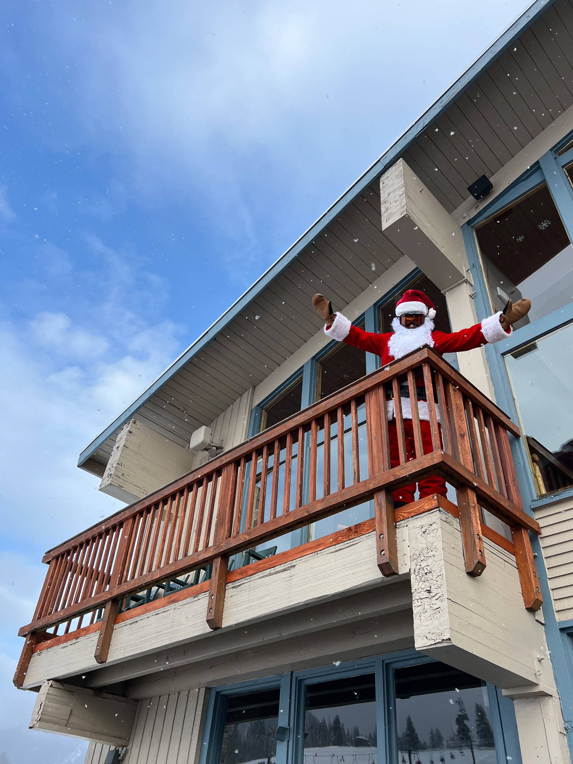 Santa character waves from the Timberwolf balcony festive holiday spirit