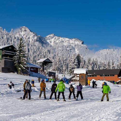 people learning to snowboard at The Summit
