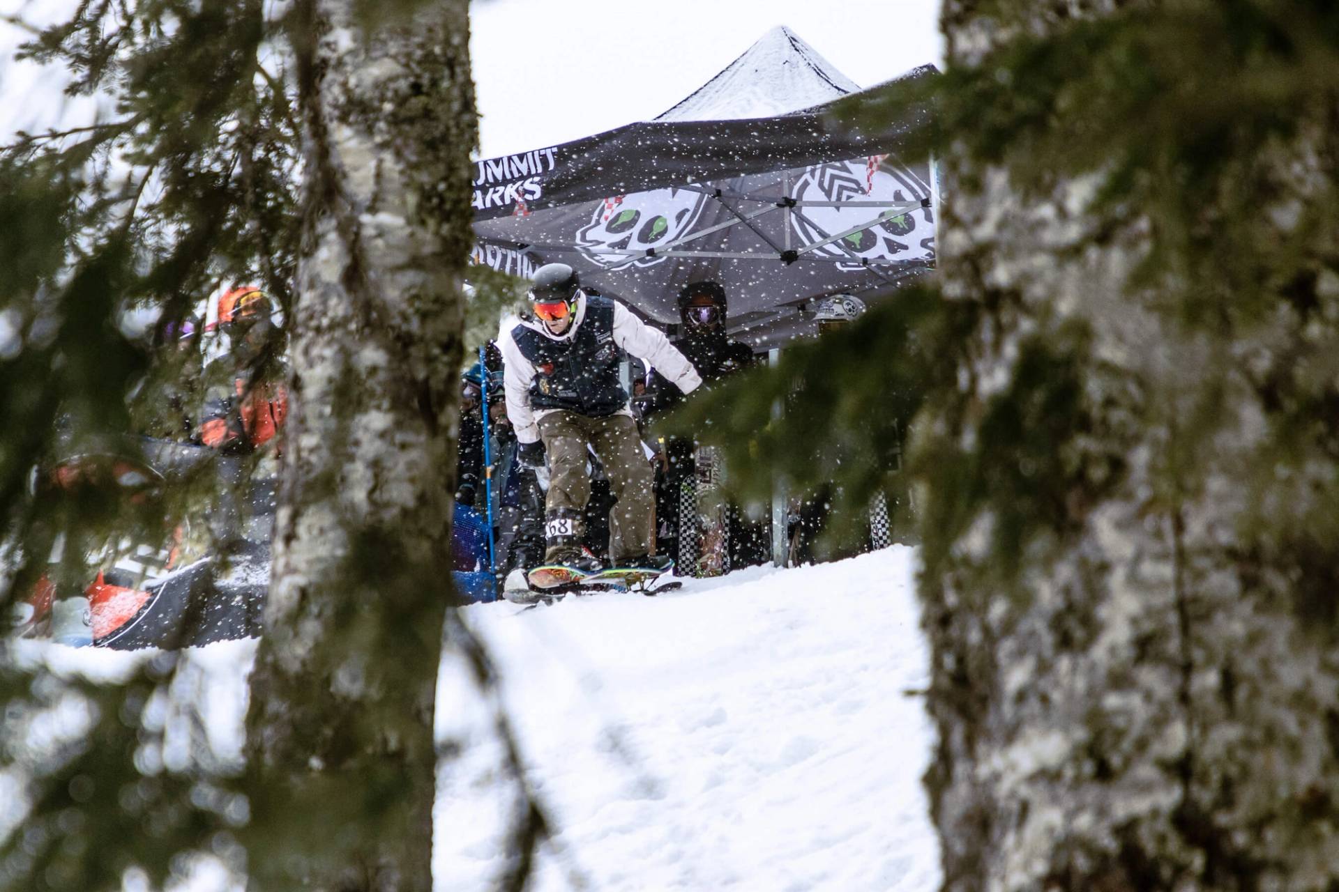 snowskater drops into banked slalom course