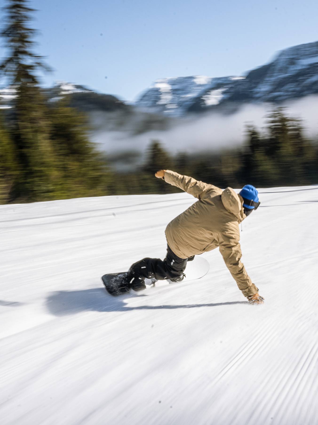 snowboarders carving turn