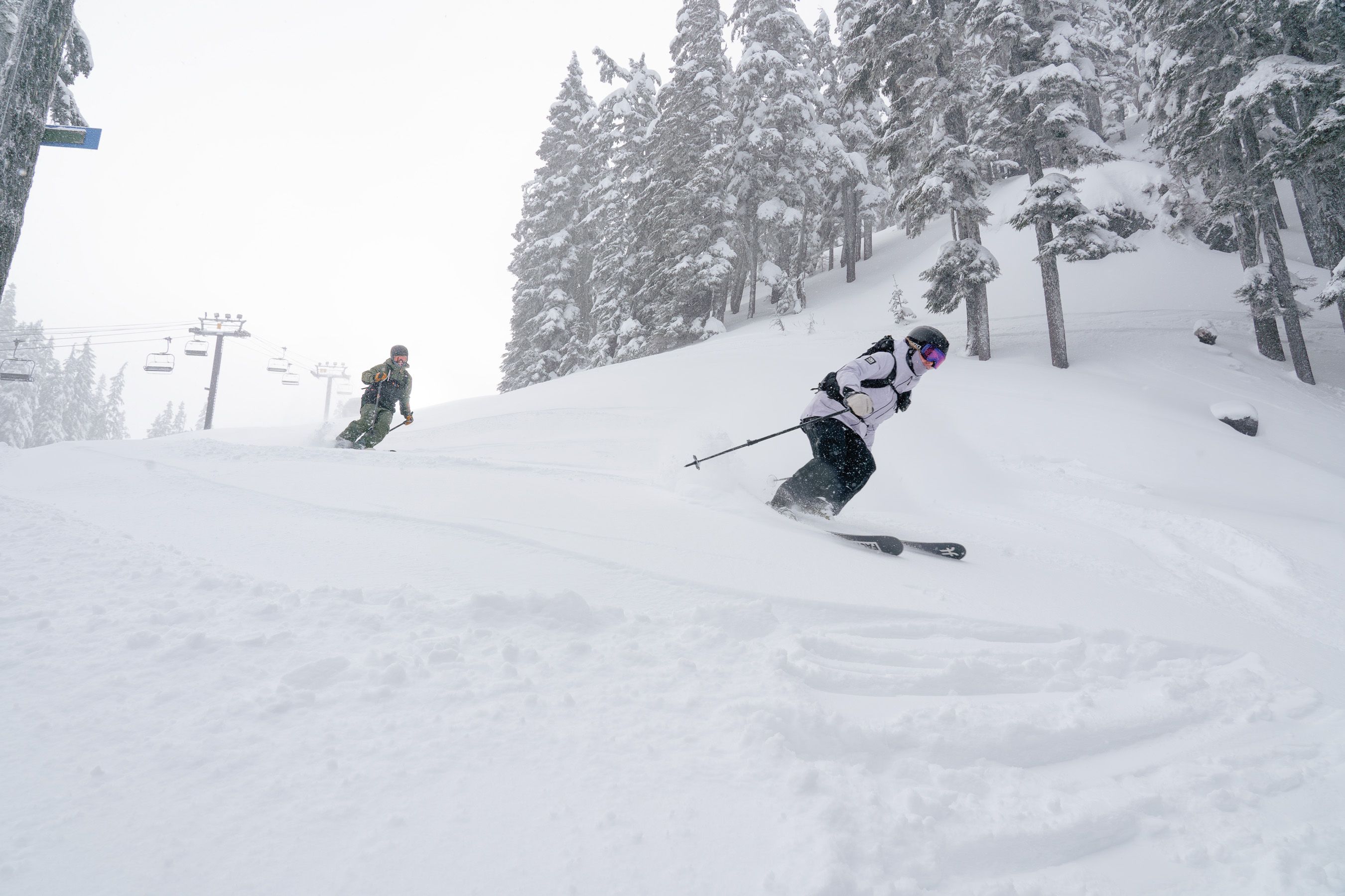 two skiers on snowy slopes