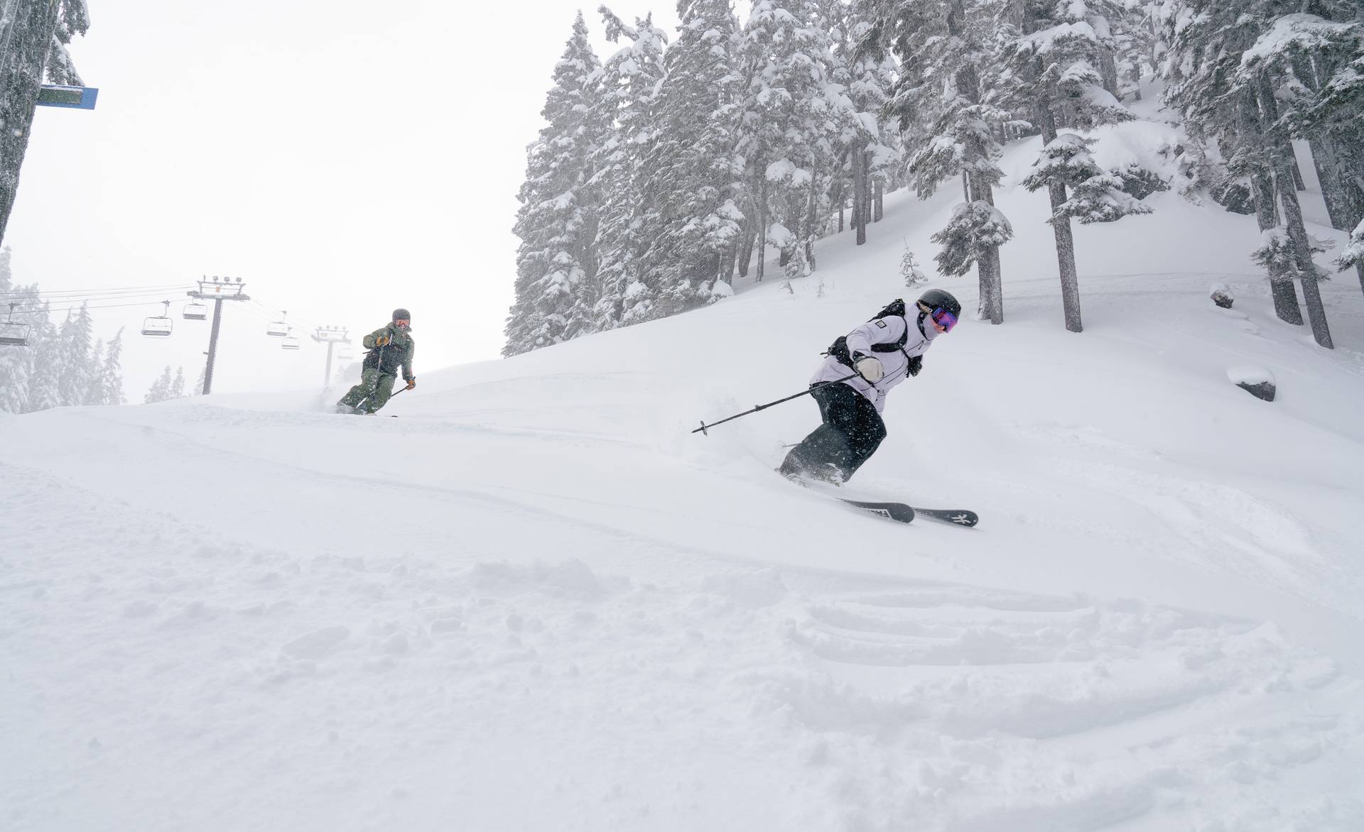 two skiers on snowy slopes