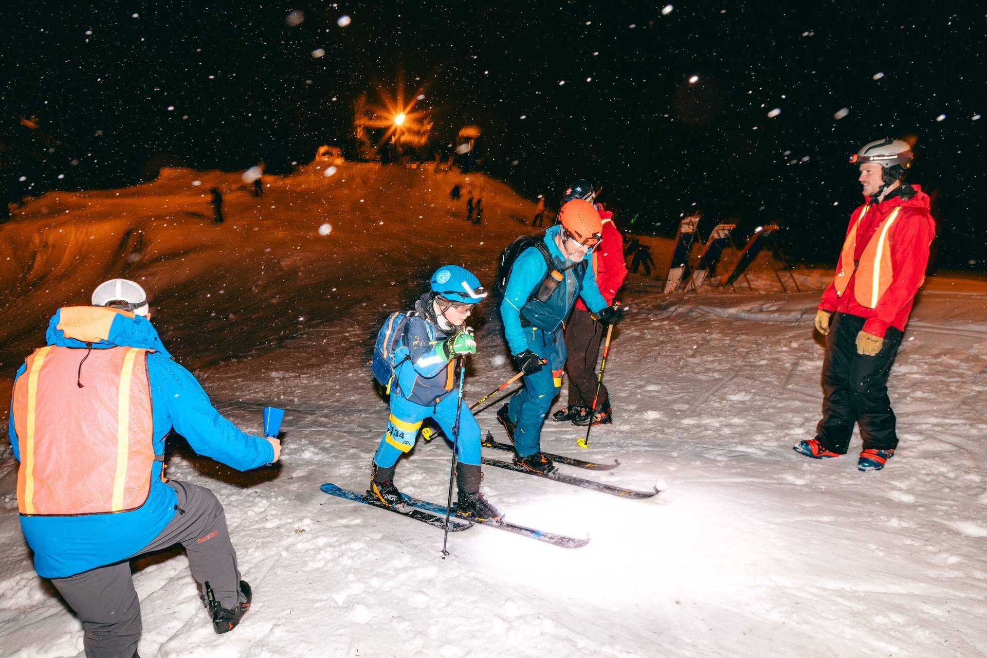 skimo racers pass a check point during night time skimo race