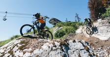 mountain biker turning on berm with a big smile
