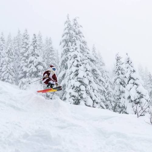 Santa catches air on skis