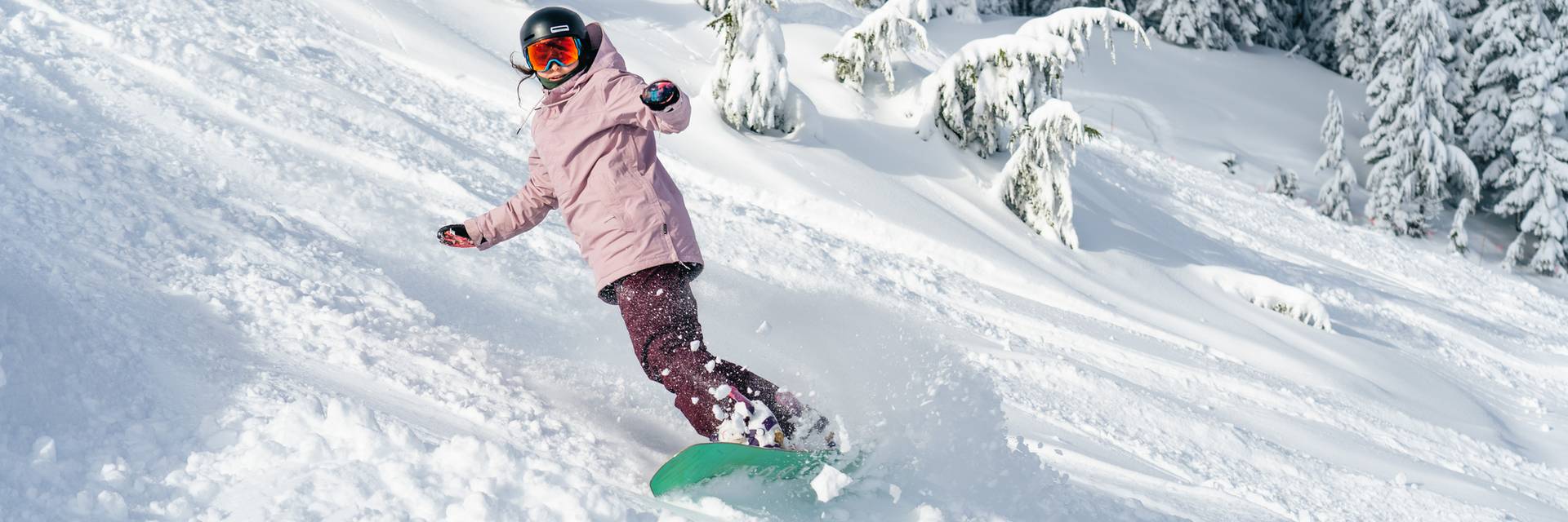 snowboarder in trees and powder