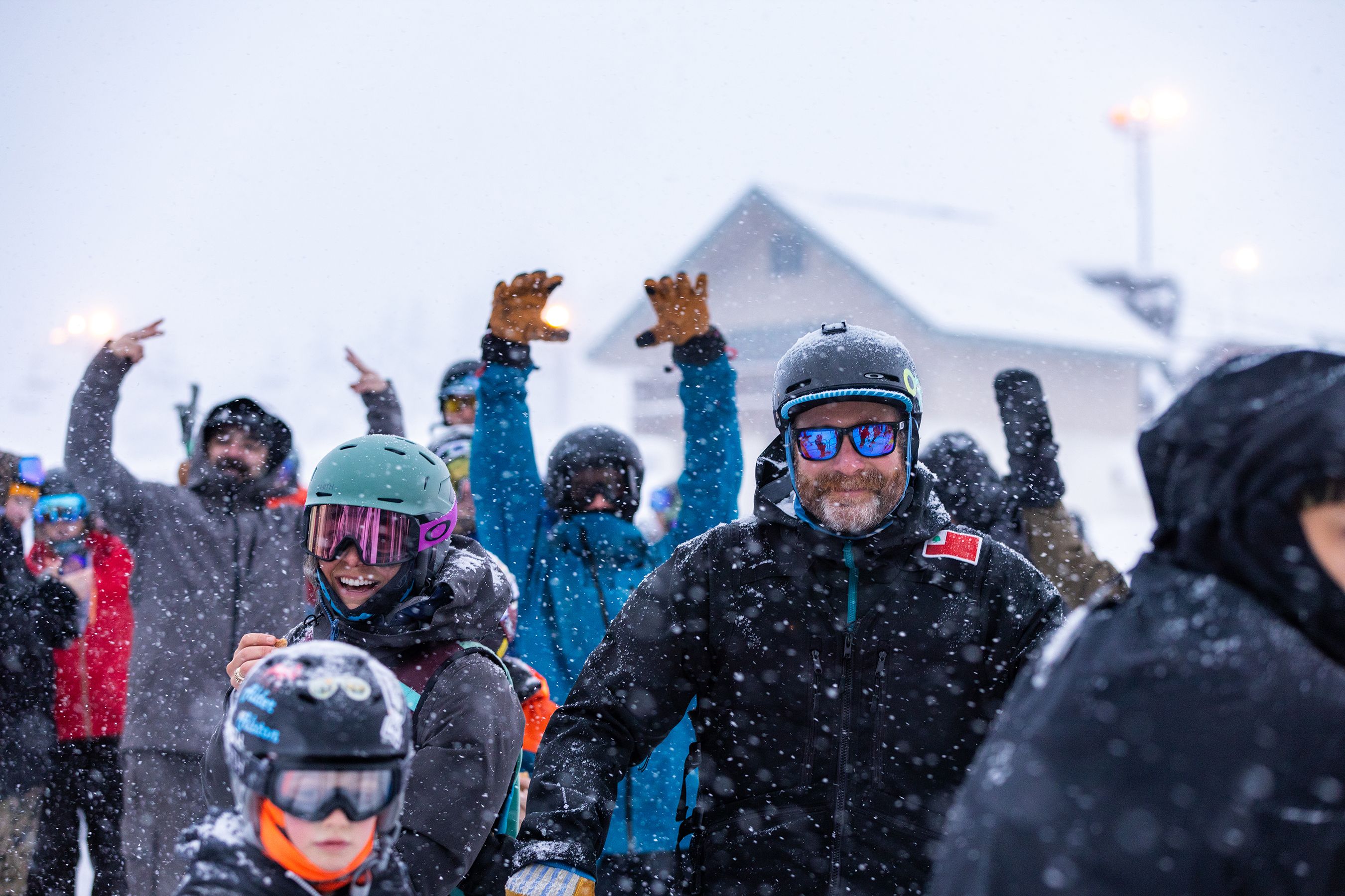 Group of skiers smiling in lift line