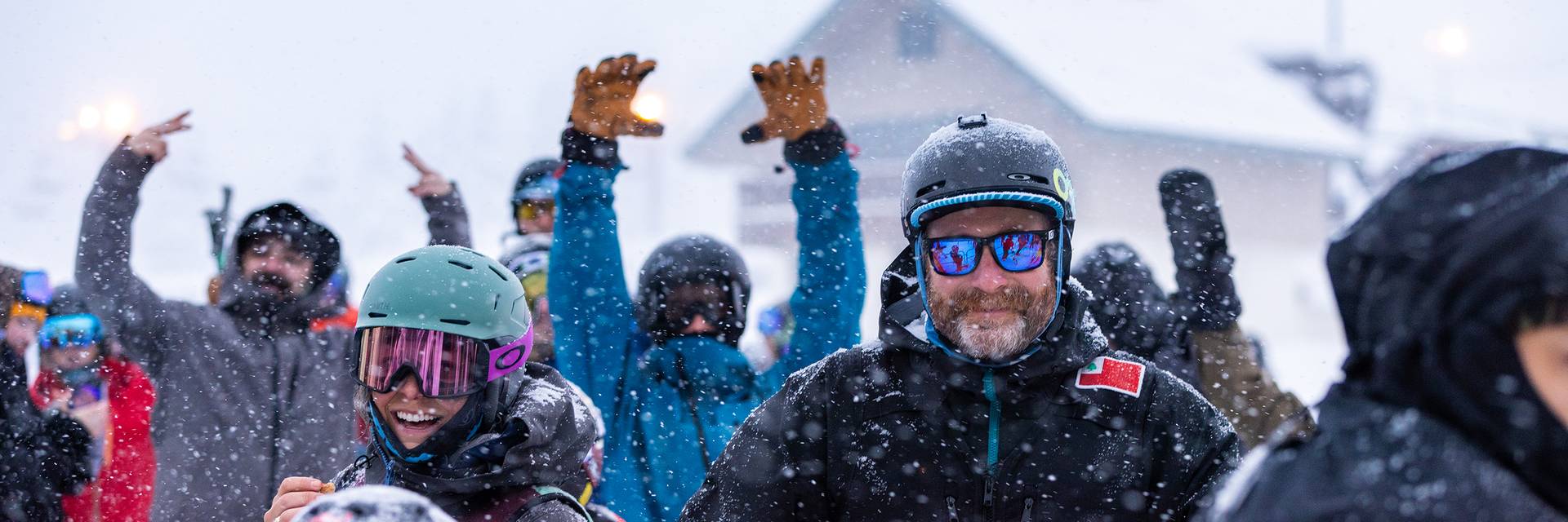 Group of skiers smiling in lift line