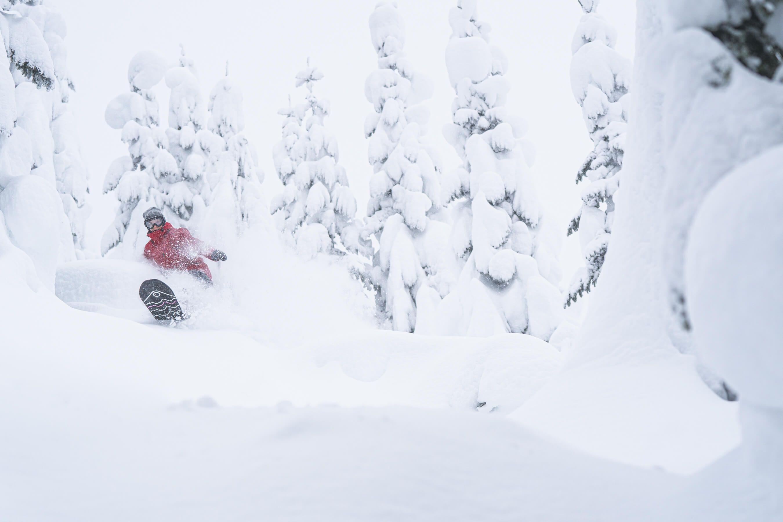 Woman snowboarding in deep powder
