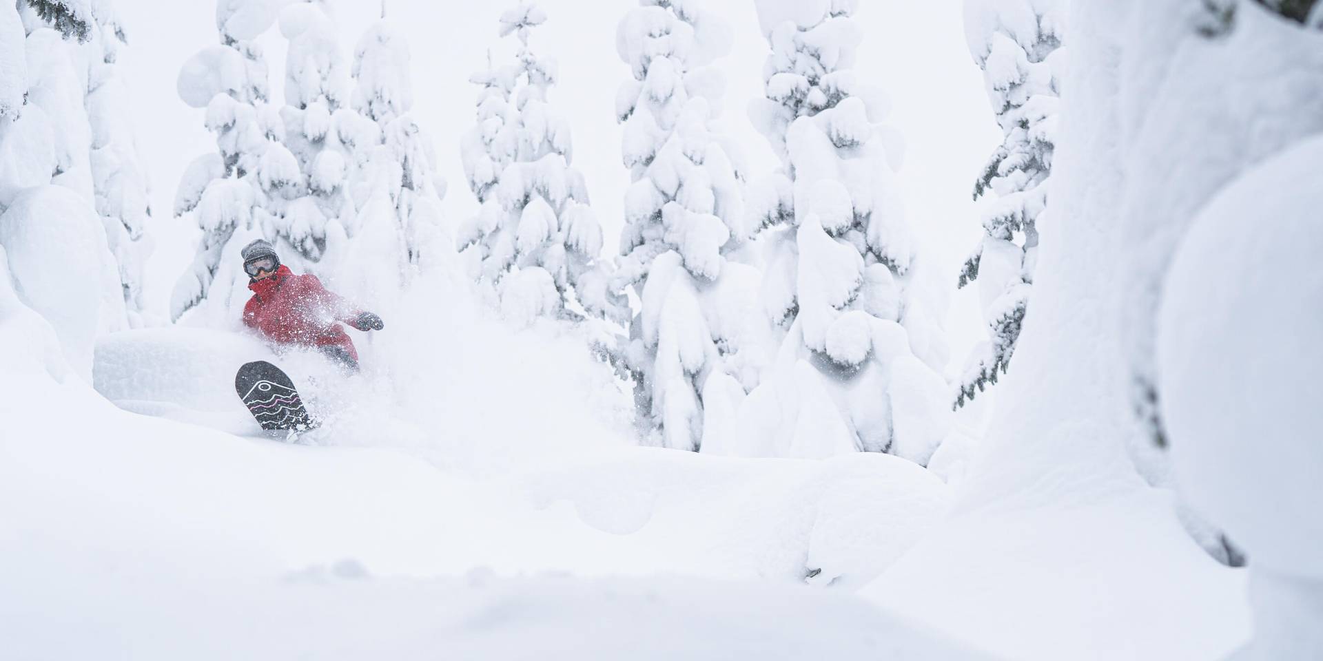 Woman snowboarding in deep powder