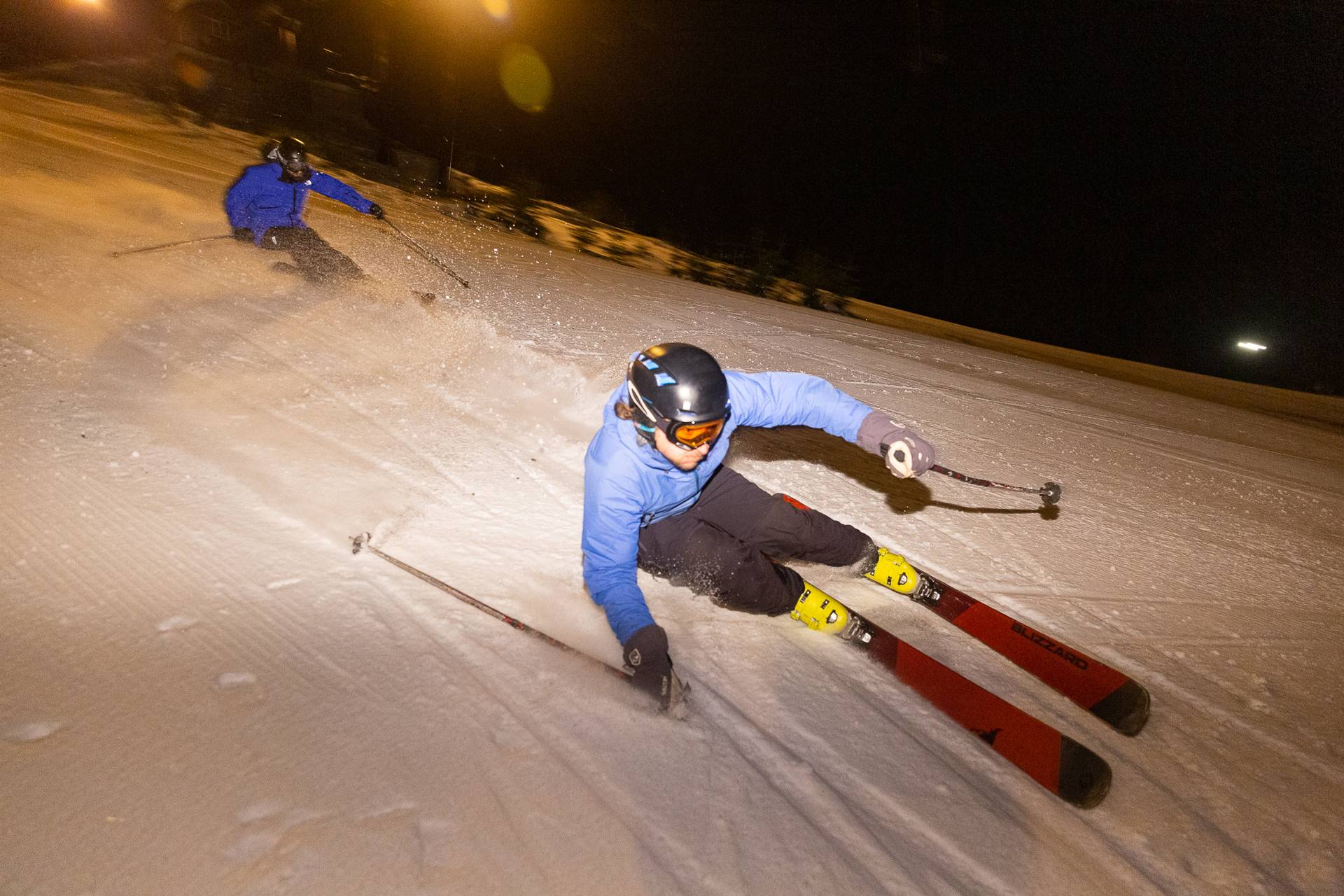 skiers speeding through the night