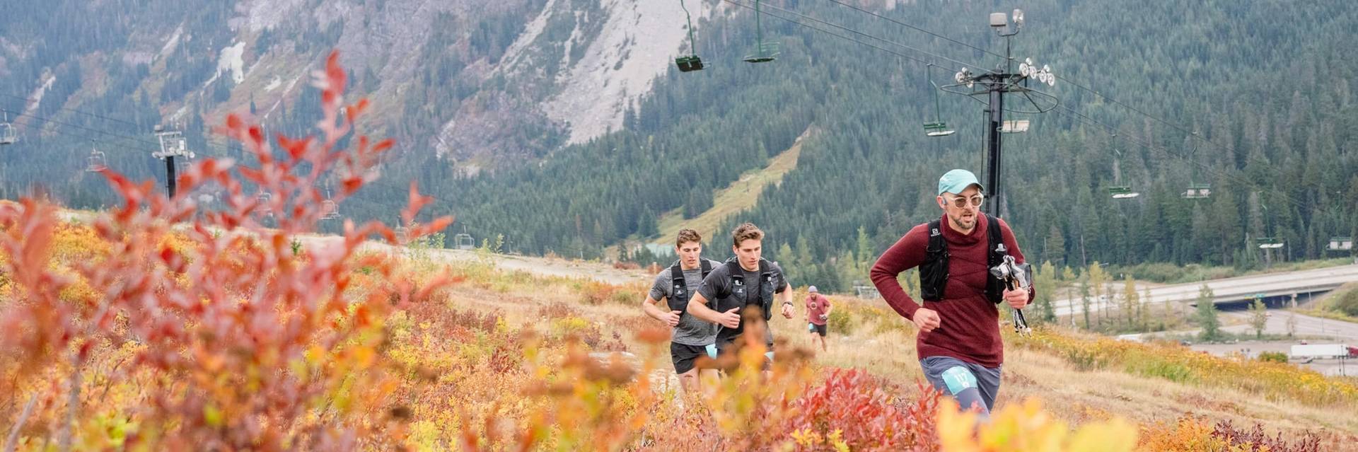 trail runners at Summit West with Guye Peak in background