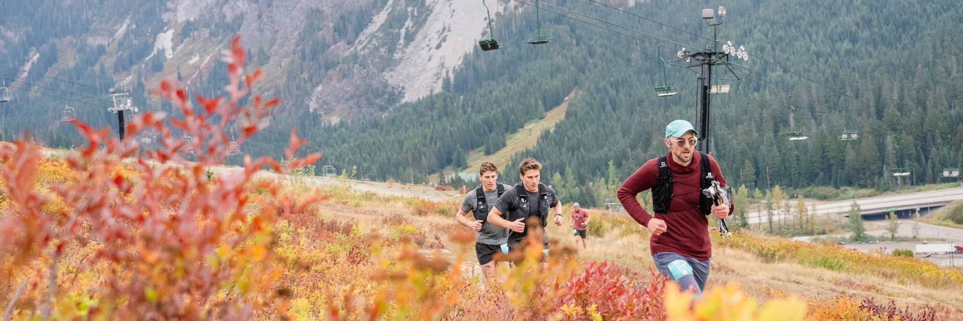 trail runners at Summit West with Guye Peak in background