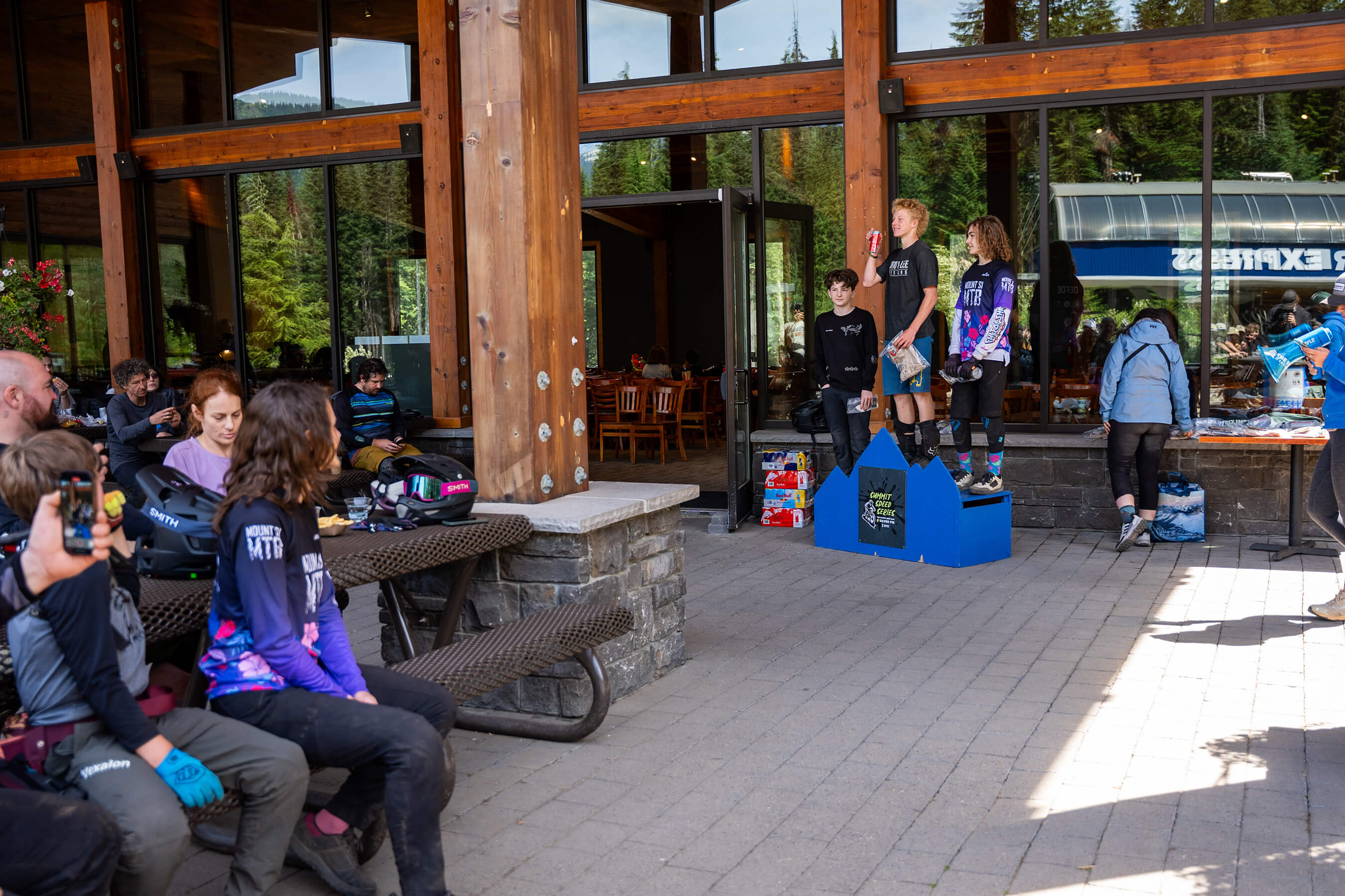 an audience watching kids line up on a podium with their prizes