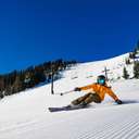 fast female skier on corduroy carving