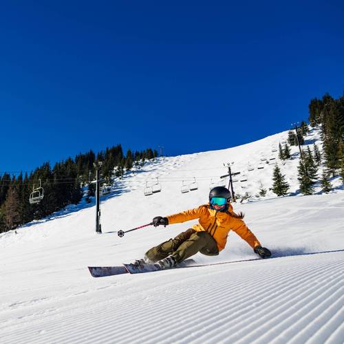girl skier carving hard