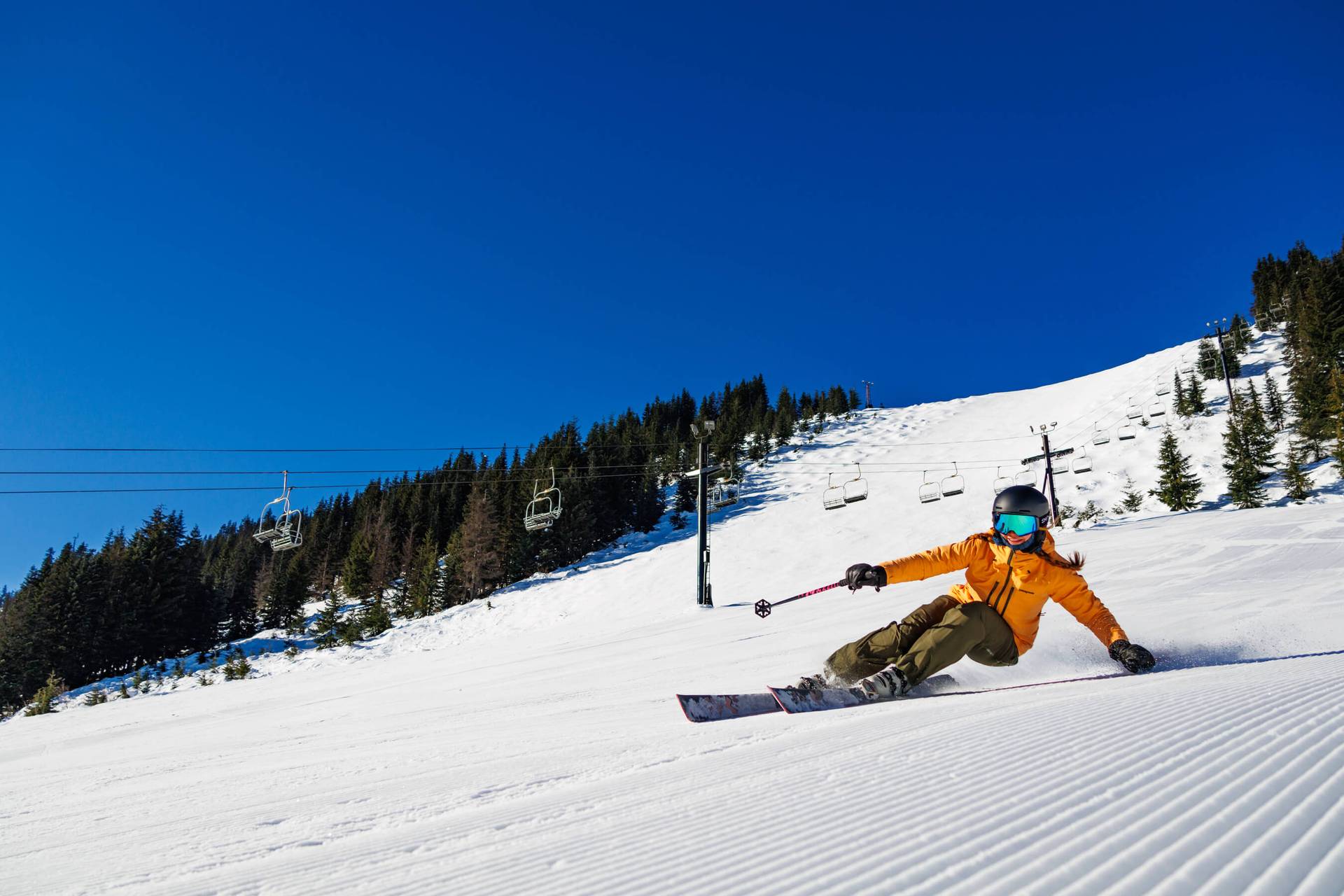skier carving on fresh groomers