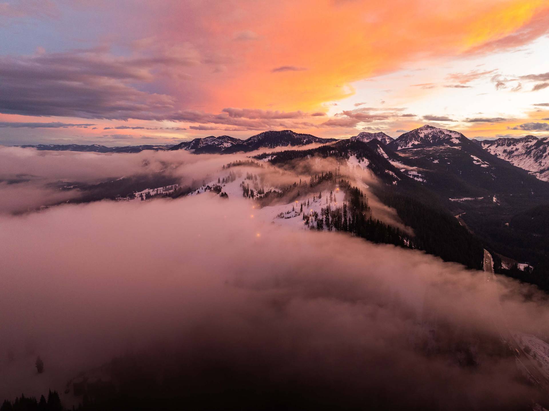 A view of a cloudy sunset over the mountains