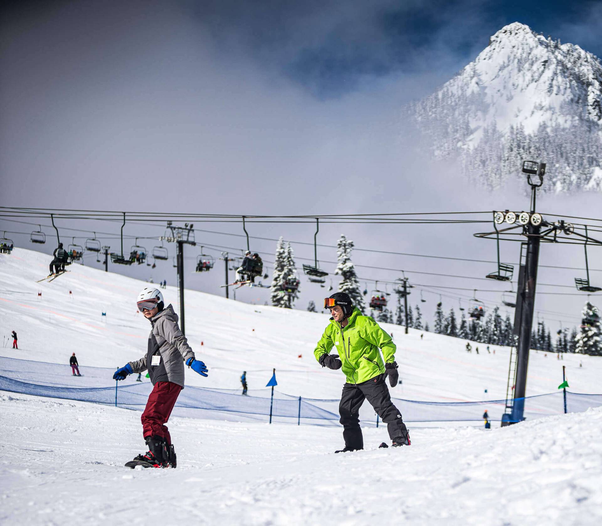 snowboarder learning to ride with instructor