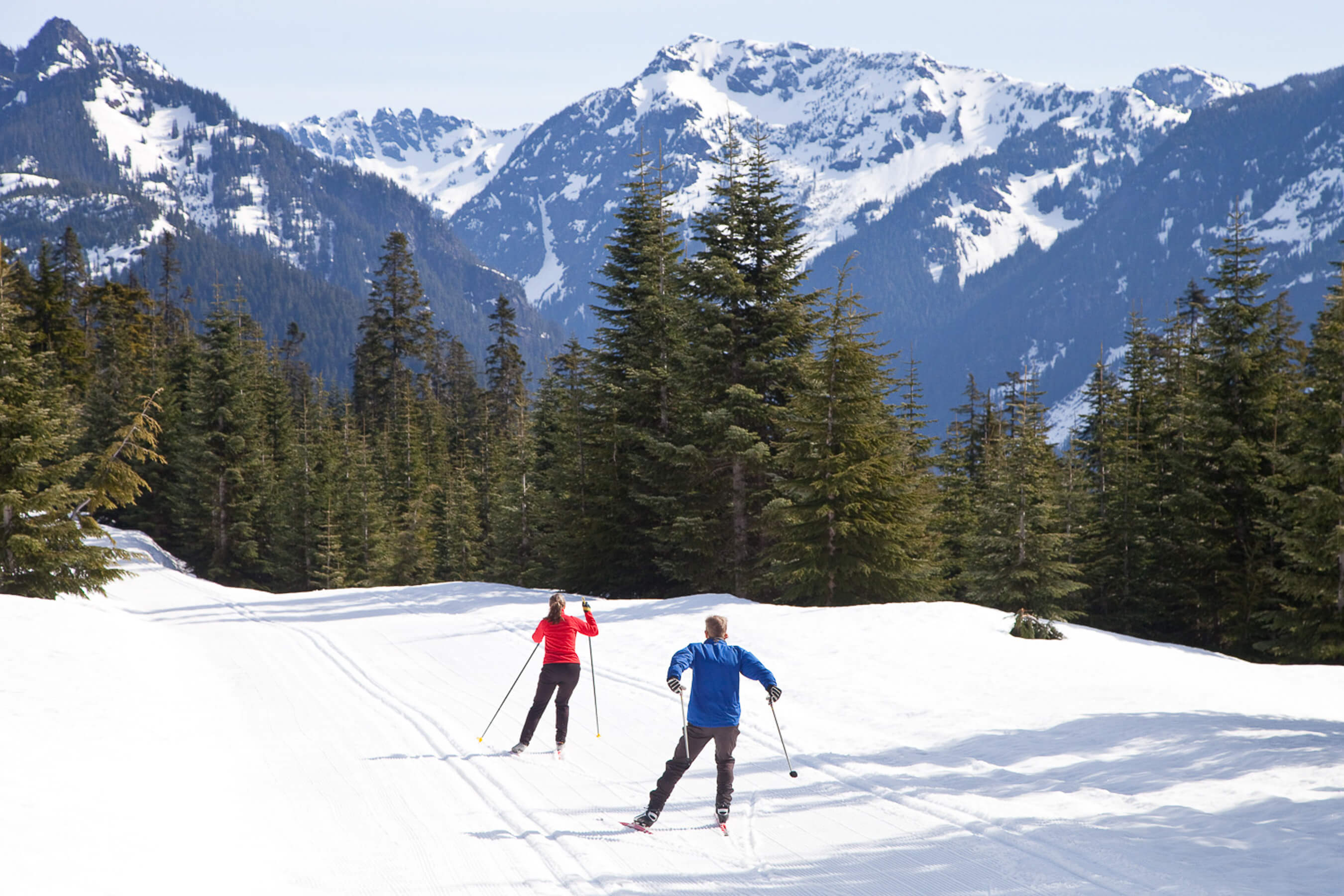 two people nordic skiing high in the mountains with views