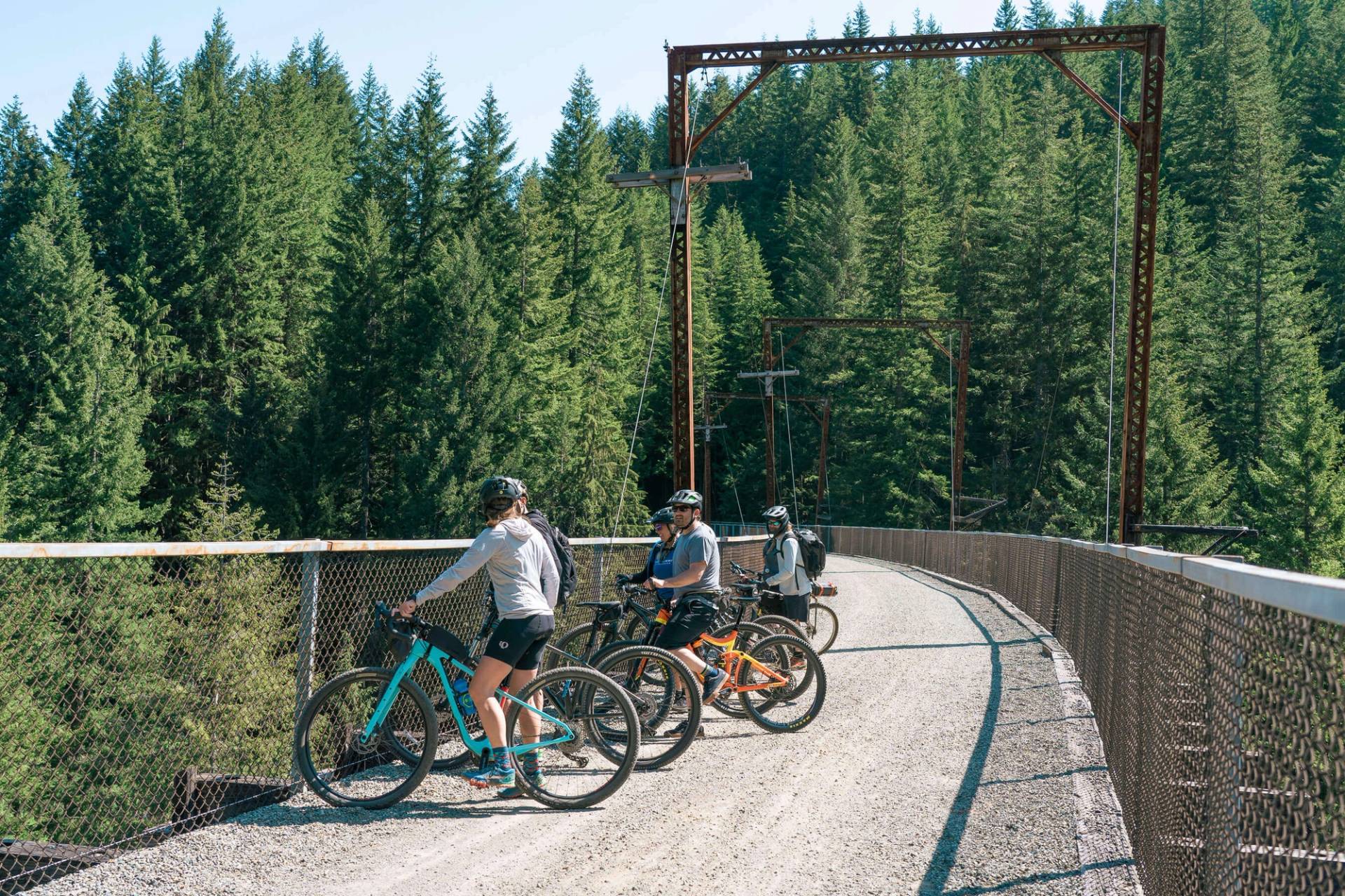 group of cyclists on bridge