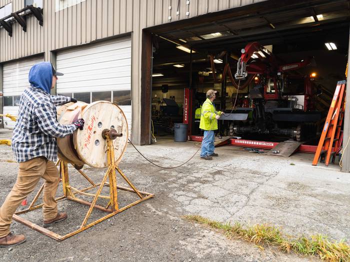 shop staff working on heavy machinery