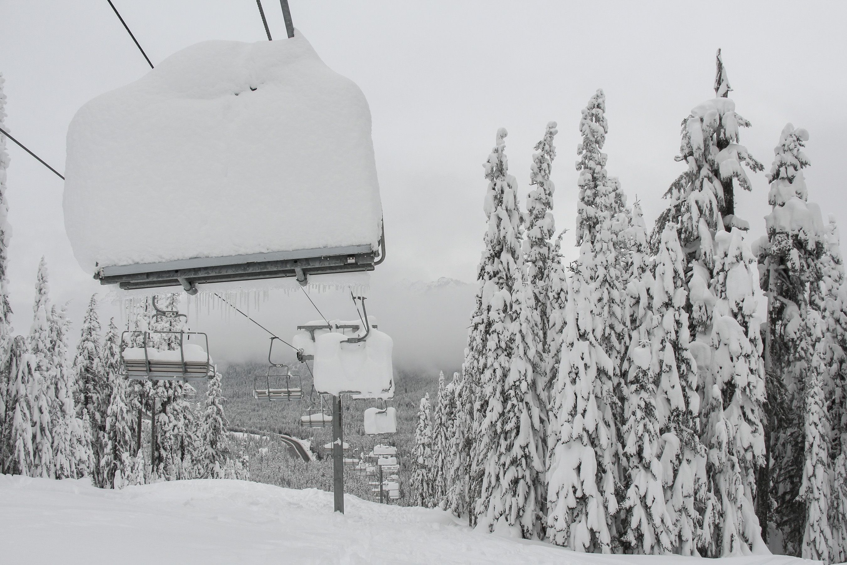 Very deep snow stacked on a chairlift at The Summit