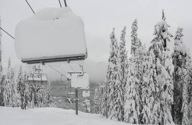 Very deep snow stacked on a chairlift at The Summit
